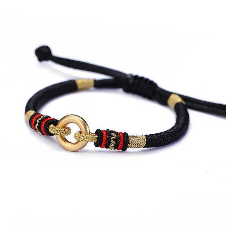 Black woven cord bracelet with gold-tone ring accent