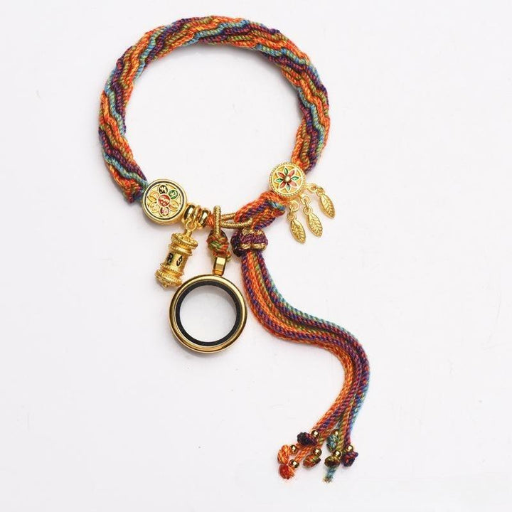 Multicolored woven bracelet with gold-tone charms