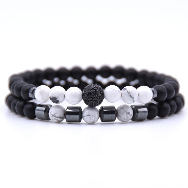 Full view of a bracelet set featuring white turquoise and black matte beads with metallic accents and a sparkling crystal centerpiece, symbolizing balance and elegance.