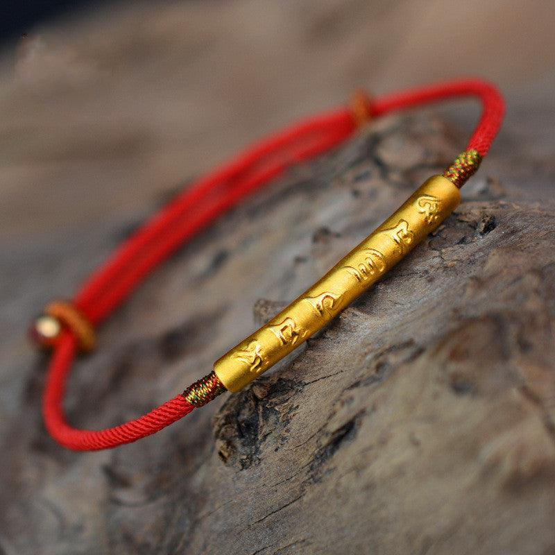 Full view of a red rope bracelet featuring the Six-Word Mantra, symbolizing protection and spiritual strength, ideal for everyday wear.