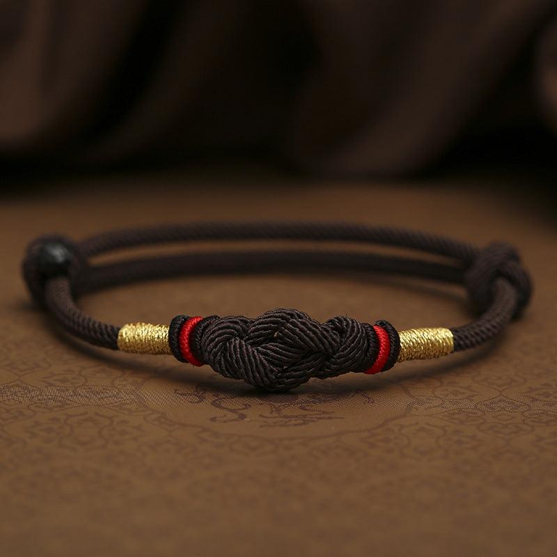 Full view of a traditional black rope bracelet with intricate knotwork, representing strength, protection, and elegance.”