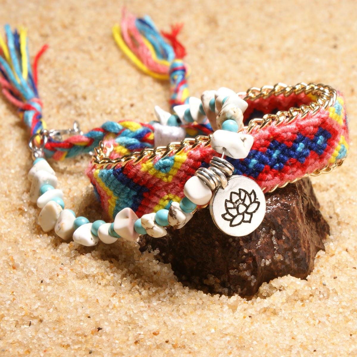 Full view of a vibrant woven anklet with turquoise and white shell beads, featuring a lotus charm that adds a touch of spiritual elegance.