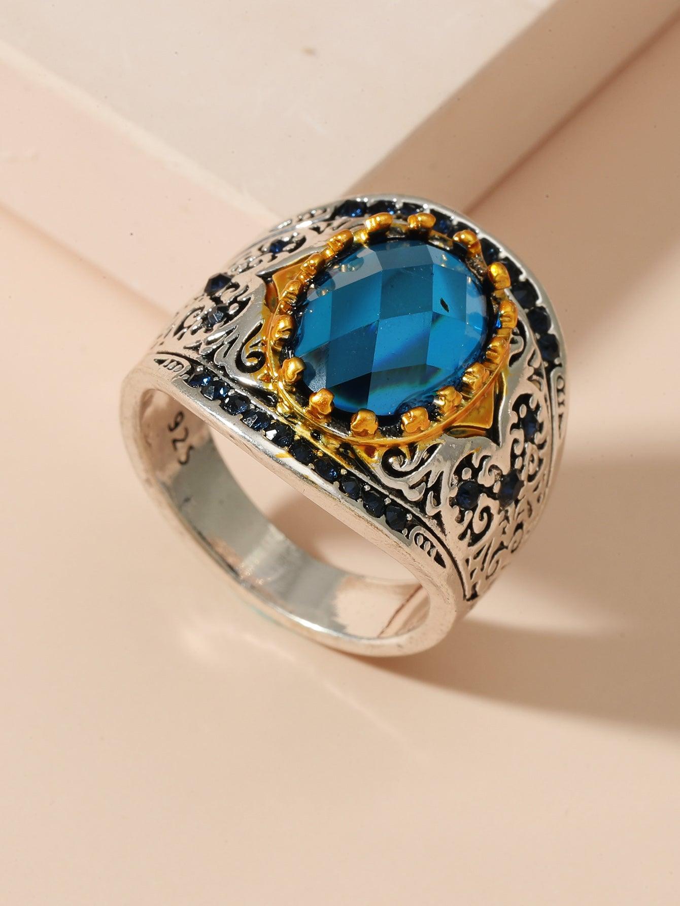 Full view of vintage sapphire ring with intricate silver detailing and gold accents, exuding elegance and mystique.