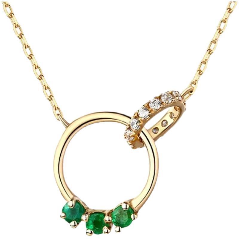 Gold and green Swarovski crystal necklace with intertwined rings, capturing a modern blend of simplicity and luxury.