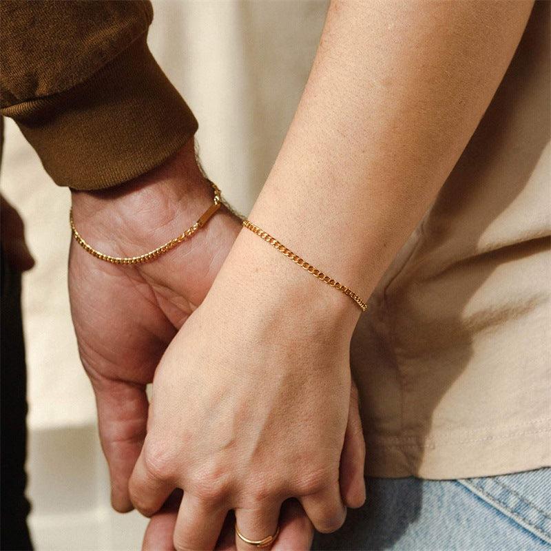 Gold bracelets worn by a couple, adding a touch of intimacy and style, perfect for couples' matching jewelry.