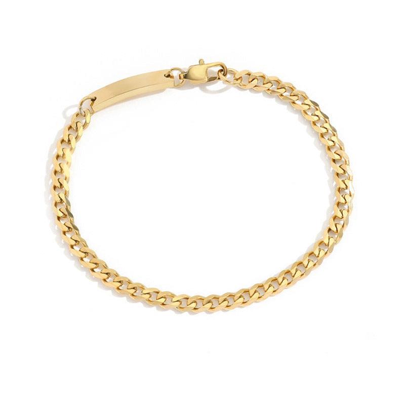 Gold necklace lying under soft natural light, emphasizing its warm gold tone and luxurious appeal.