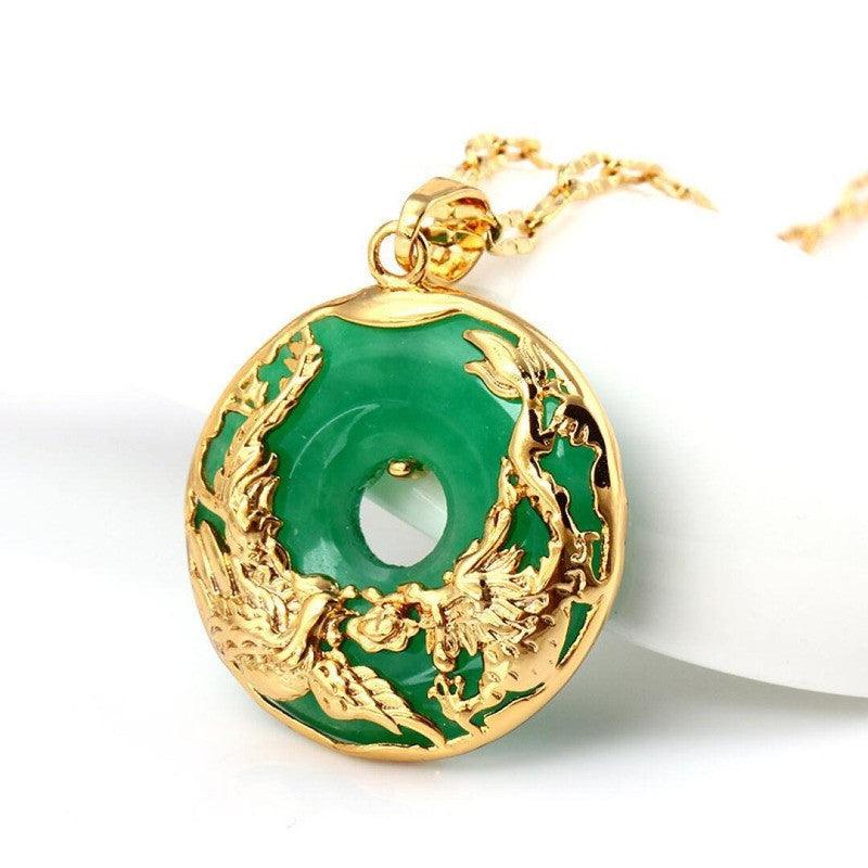 Green stone pendant with golden dragon displayed in natural lighting, capturing its vivid colors and intricate design.