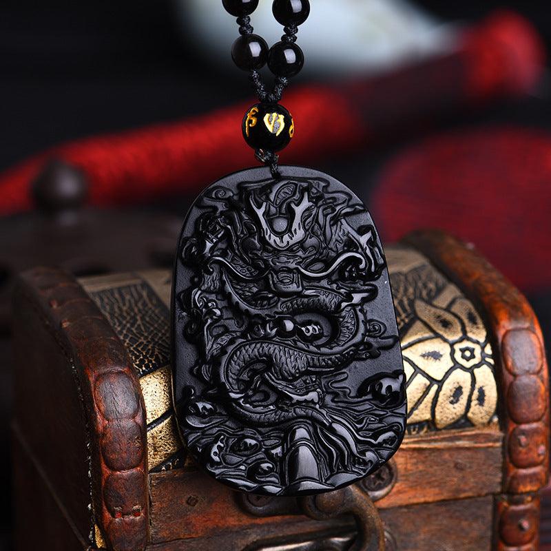 Hand-carved black obsidian dragon pendant, symbolizing strength and protection, an ideal talisman for daily wear.