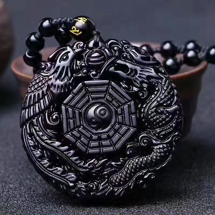 Hand-carved black obsidian pendant featuring the Eight Trigrams and Yin-Yang symbol, symbolizing balance and protection.