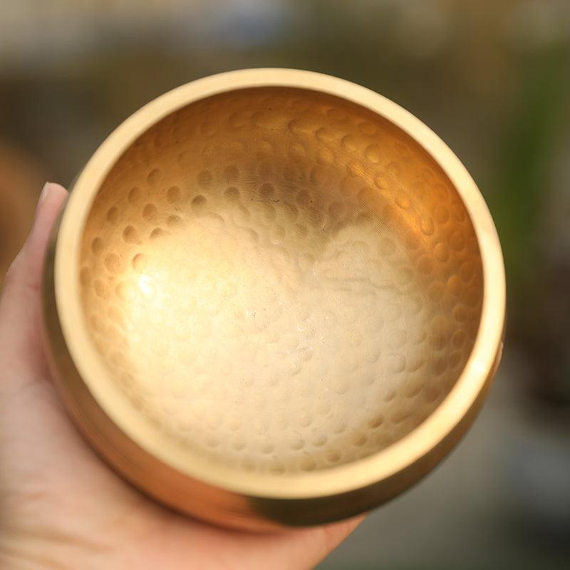 Hand-hammered brass singing bowl with subtle decorative patterns, showcasing traditional Tibetan craftsmanship passed down through generations.