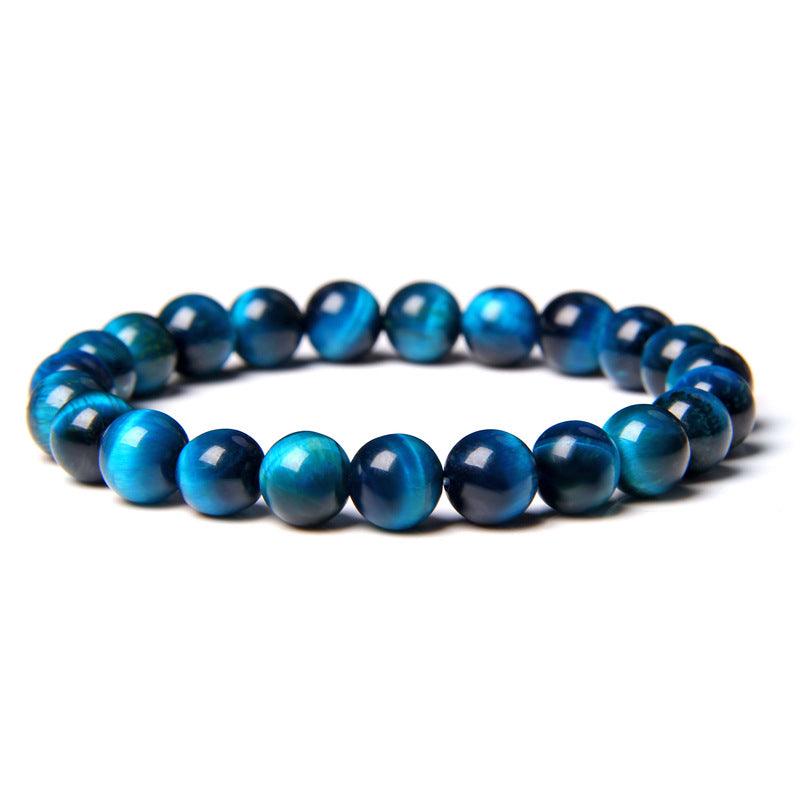 Handcrafted blue tiger eye bracelet with a smooth finish, each bead uniquely patterned, showcasing artisan attention to detail.