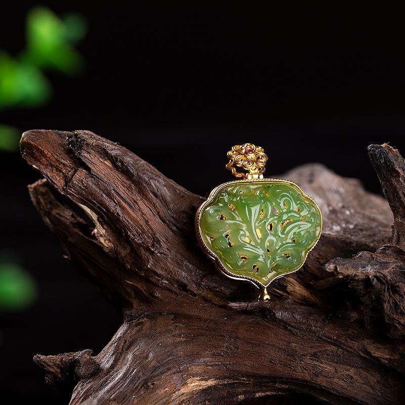Handcrafted jade pendant with intricate gold detailing, reflecting the artisan’s meticulous attention to detail and cultural significance.
