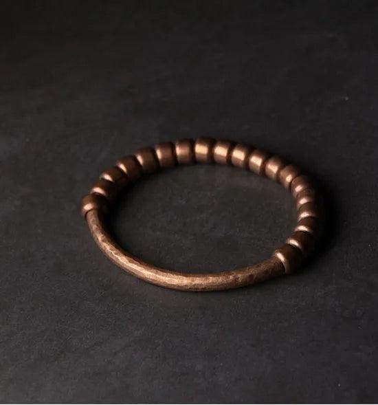 Handcrafted metal bracelet with a unique hammered texture, ideal for those seeking a rugged and timeless style.