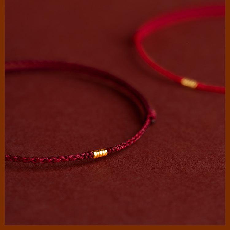 Handcrafted red string bracelets with gold accents, adding a touch of luxury to traditional good luck charms.