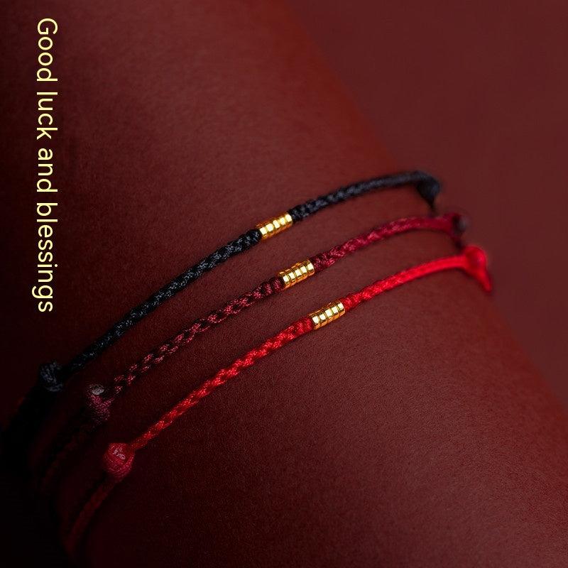 Handwoven bracelets in black, deep red, and red, each accented with golden beads for an elegant touch.