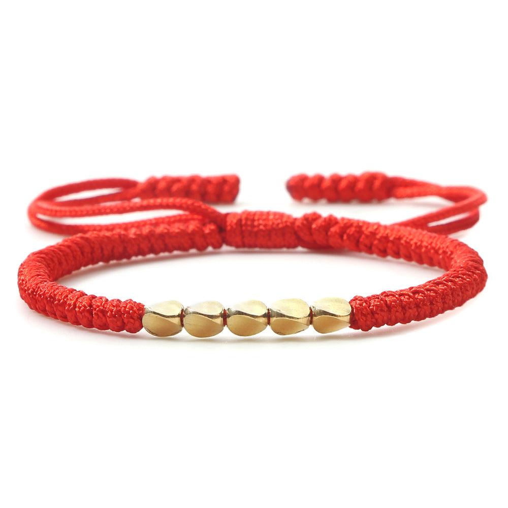 Handwoven red string bracelet featuring smooth gold beads, a classic combination that brings luck and positivity to the wearer.