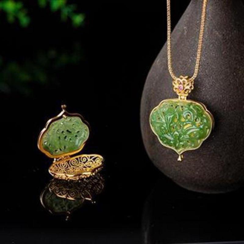 Intricate jade pendant with gold-plated frame and delicate floral carvings, symbolizing elegance and spiritual balance.