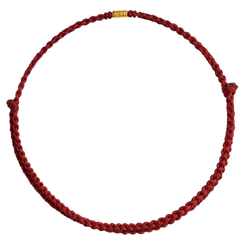 Minimalistic red rope bracelet with gold details, symbolizing luck, love, and protection.