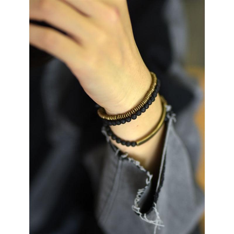 Modern black obsidian and brass bracelet, enhancing any minimalist style.