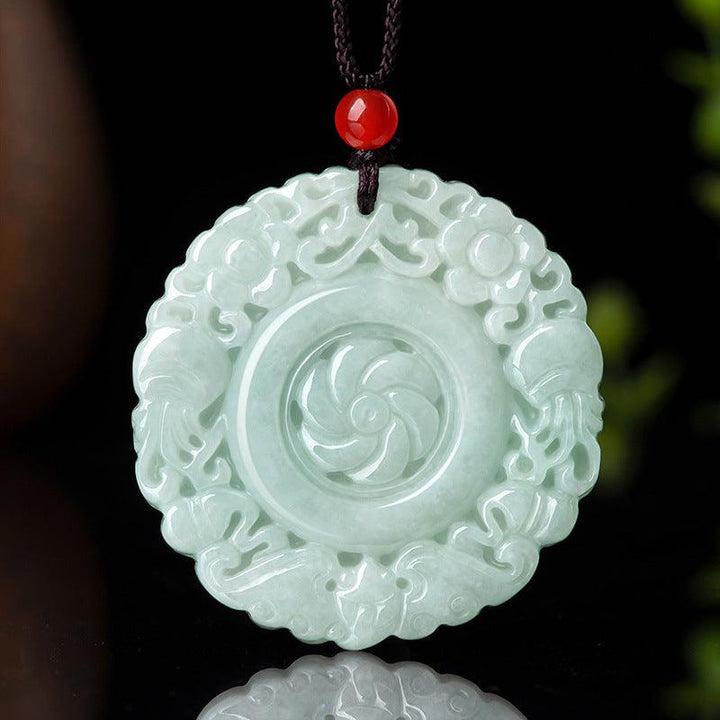 Green flower-shaped jade pendant with polished carved petals