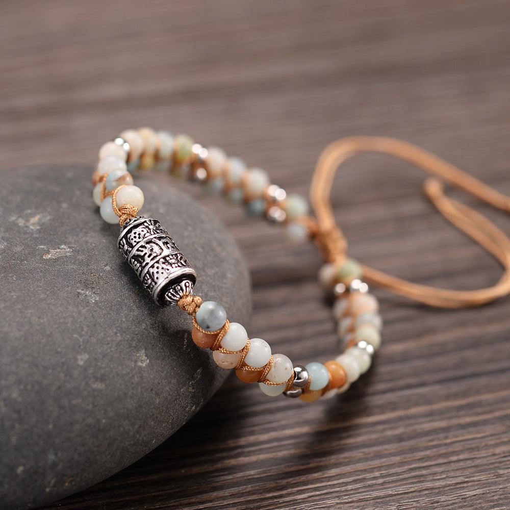 Natural agate bracelet with Tibetan Six-Word Mantra silver prayer wheel, a symbol of peace and protection.