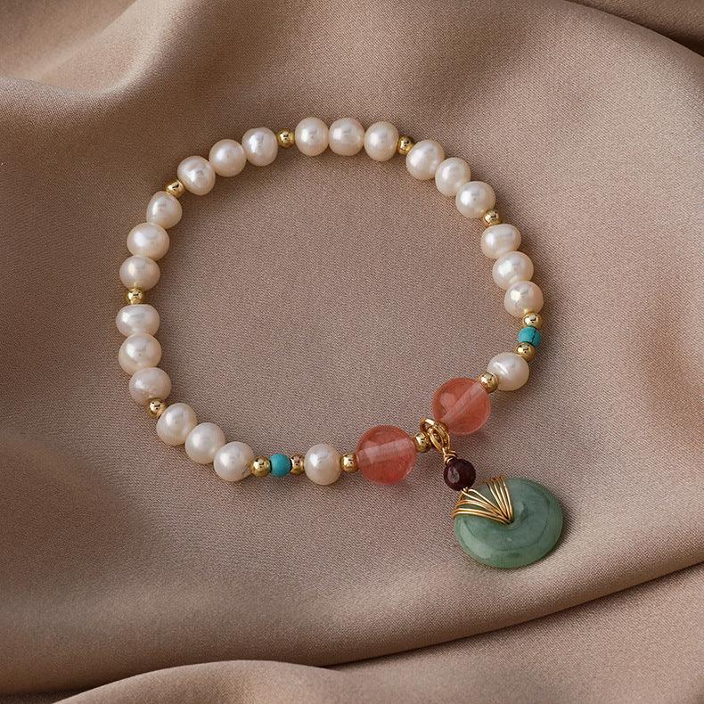 Pearl and gemstone bracelet combining symbols of peace, energy, and balance, appreciated in both Eastern and Western traditions for its beauty and positive aura.