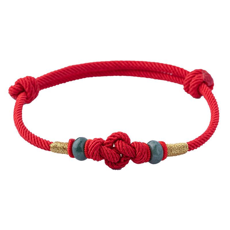 Red rope symbolizes luck and protection in Chinese culture, combined with jade for balance and prosperity.