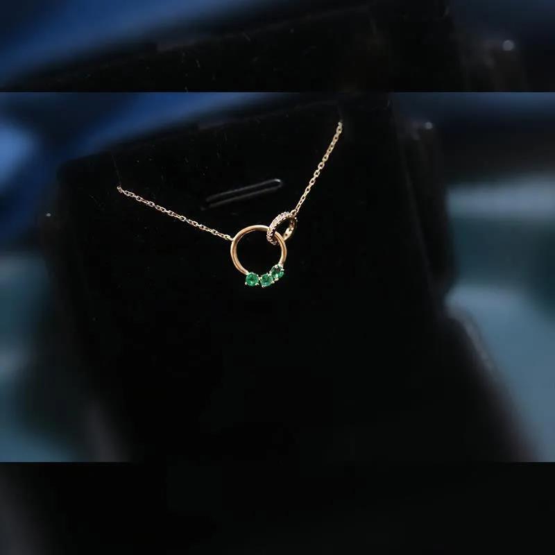 Refined Swarovski necklace with dual rings and emerald-green crystals, adding a chic statement to any look.