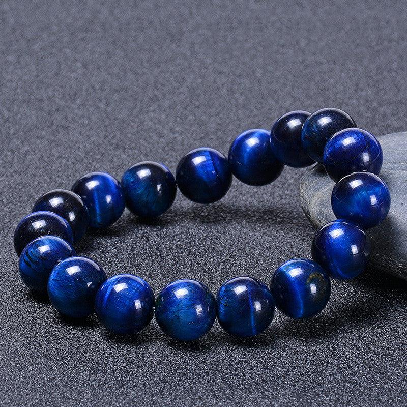 Side view of the bracelet showcasing the rich depth of blue hues and reflective qualities of the tiger eye stones, adding an aura of mystery.