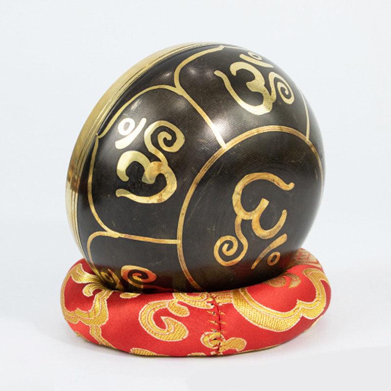 Singing bowl adorned with sacred symbols, widely used in Buddhist rituals for meditation, healing, and energy cleansing practices.