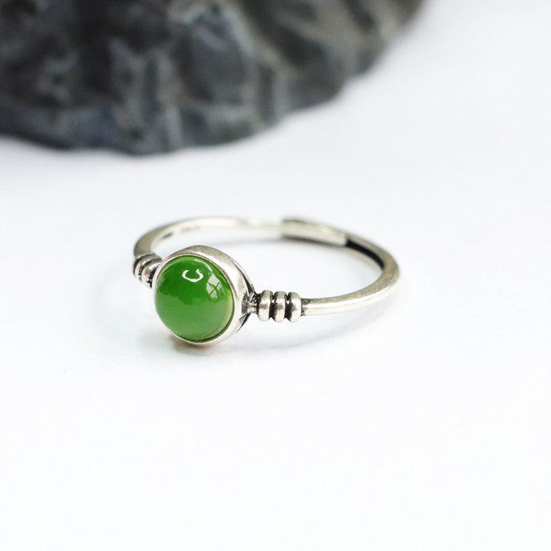Sterling silver ring featuring a polished green jade stone, symbolizing serenity and balance.