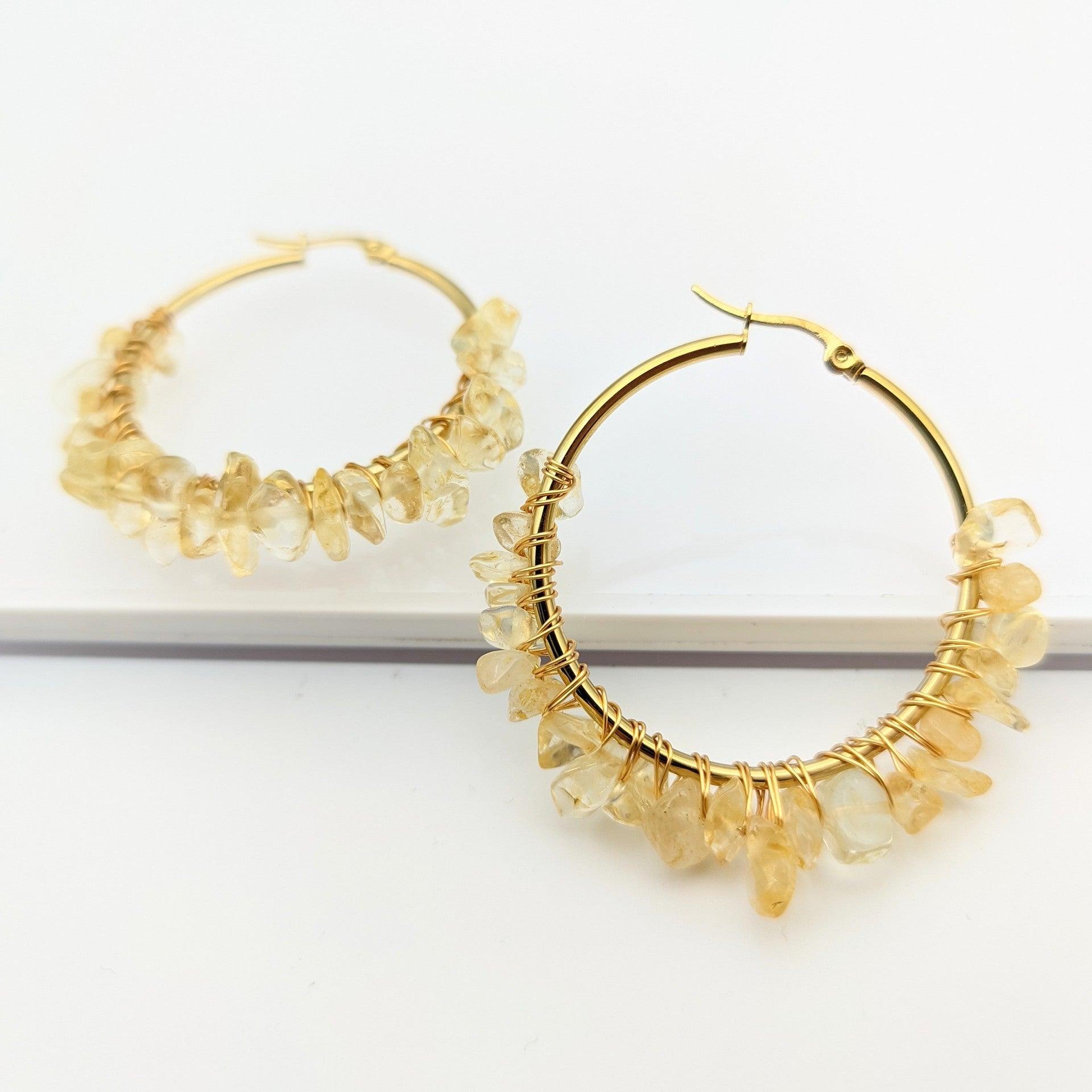 These gold hoop earrings with green natural stones symbolize vitality and growth, echoing the refreshing spirit of nature. Green gemstones are often seen as symbols of balance and health, bringing inner peace and grounding energy to those who seek harmony with nature