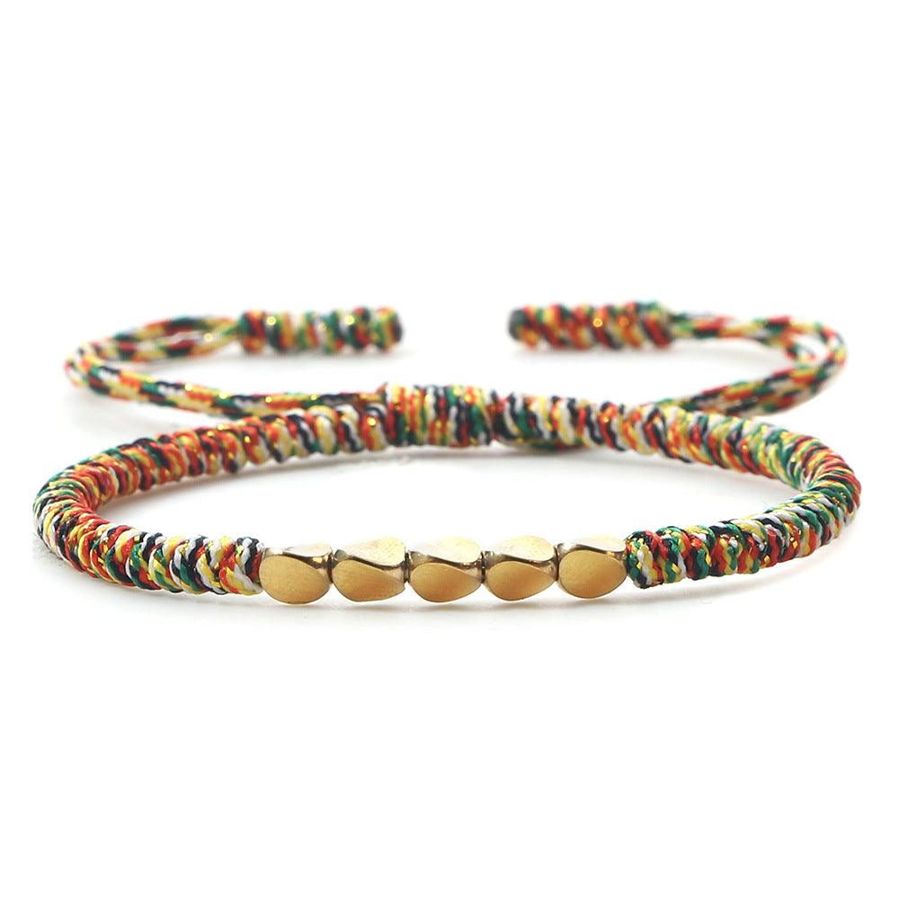 Vibrant multicolor braided bracelet with gold beads, a unique accessory blending tradition and modern style.