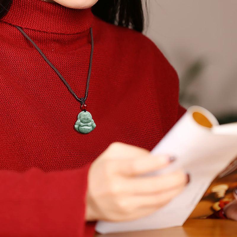 Worn view of the jade Buddha pendant, bringing a touch of spiritual elegance to daily life.