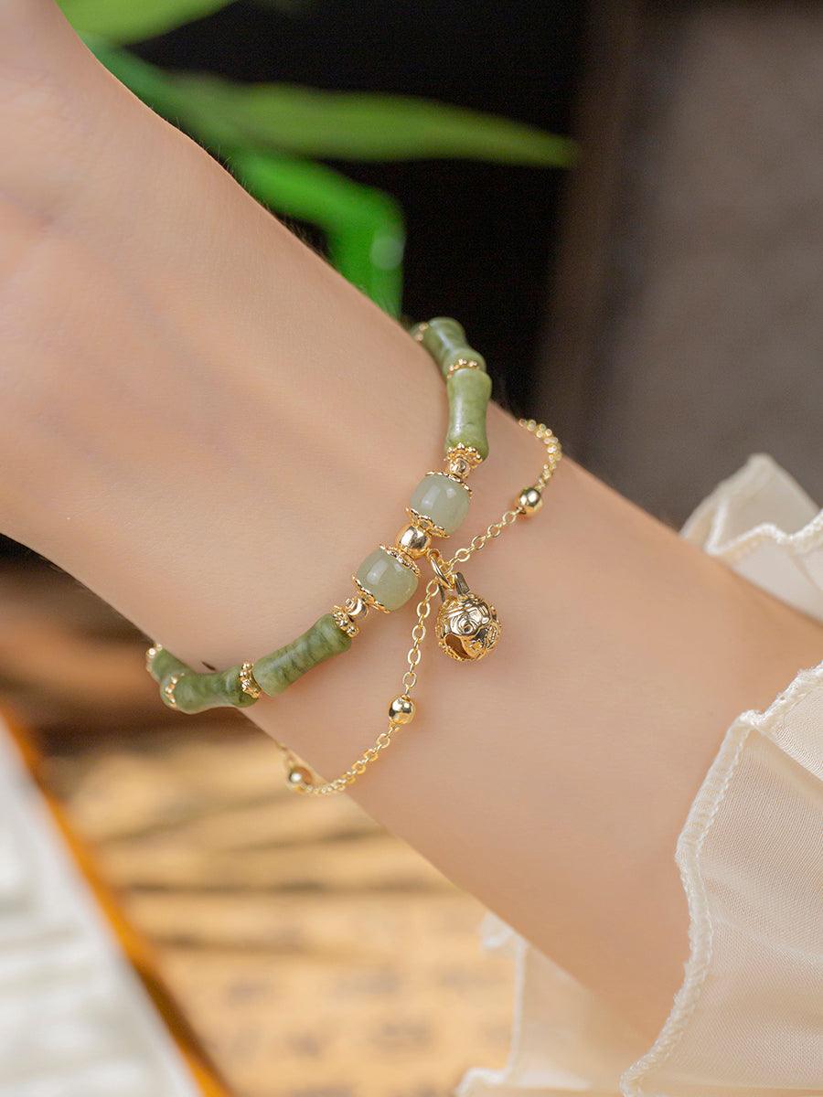 Worn view of the jade and gold bracelet, adding a sophisticated touch to any outfit.